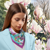 Woman wearing a colourful blossom silk twill scarf with a floral background